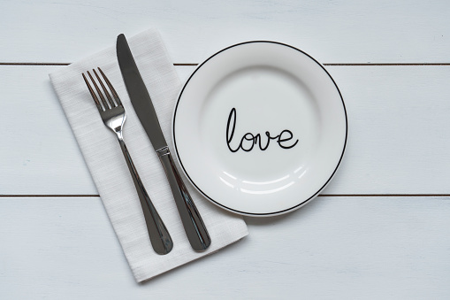 Empty plate and napkin on wooden background