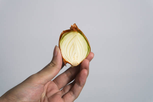 istock hand holding sliced Garlic isolated on white background 1814257908