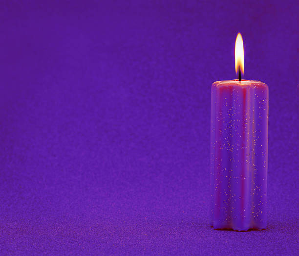 Purple holiday candle with glitter background