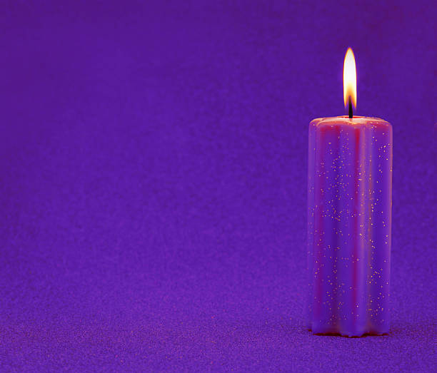 Purple holiday candle with glitter background stock photo