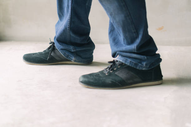 istock A mans denim-clad lower half with casual footwear. 1814273884