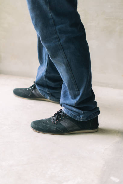 istock A mans denim-clad lower half with casual footwear. 1814274419