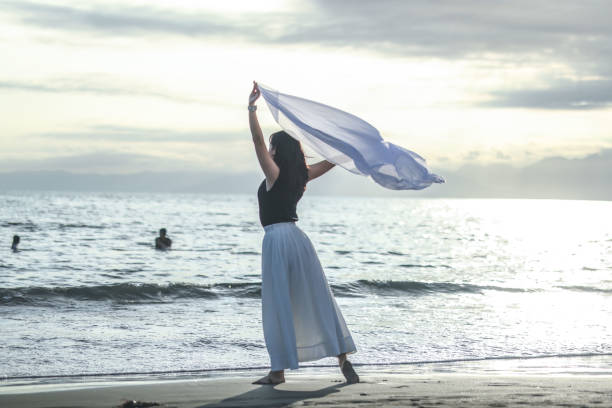 istock Beautiful lady dancing at beach side 1814277304