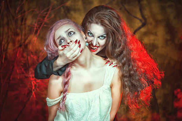 istock Halloween vampire and her victim 181428648