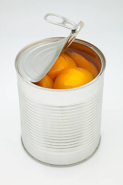 istock An open can of peaches on a white background 181428997