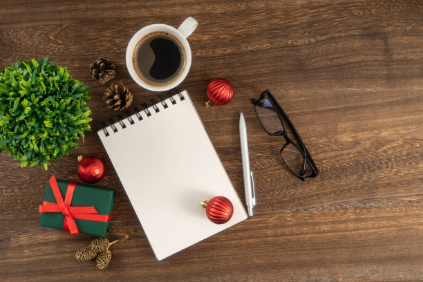 istock Holiday decorations and notebook on wooden table from above, Christmas planning concept. 1814303517
