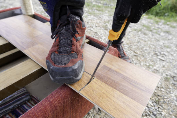 istock Man cutting wood with saw 1814304082