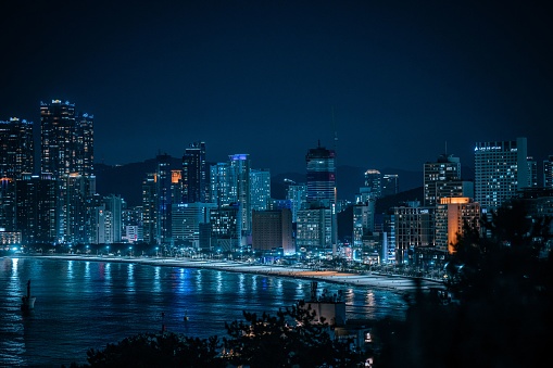 An awe-inspiring aerial shot of the beachfront in Busan at night.