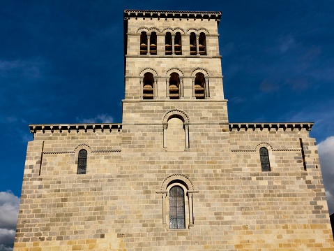 Issoire, France – June 16, 2023: The West facade of the church of Saint-Austremoine d'Issoire, France.
