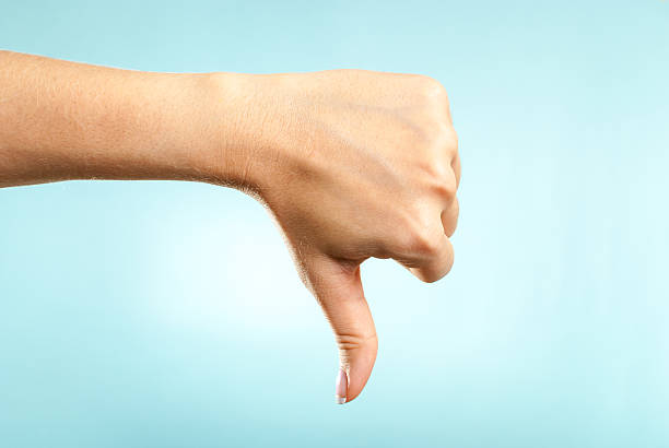 Human hand making dislike dissatisfaction bad disagreement discontent gesture stock photo