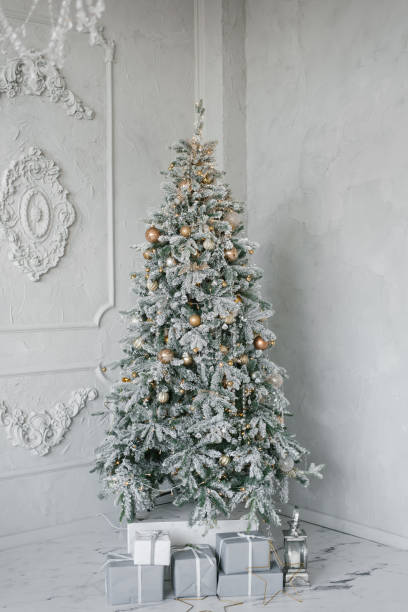 istock Silver Christmas tree with gifts under it in a classic interior 1814367268