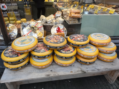 December 31st, 2017 Amsterdam, Netherlands. Traditional Dutch cheese on a table in front of cheese shop