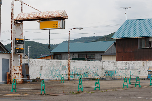 June 28th, 2022 Horokanai, Hokkaido, Japan. Old abandoned petrol station in a rural town