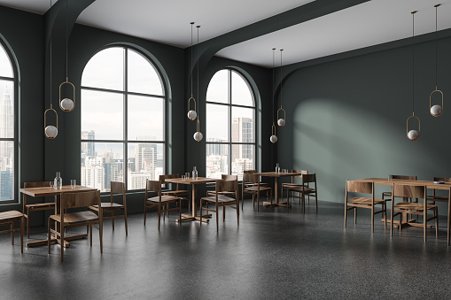 Dark green restaurant interior with wood chairs and table in row, side view grey granite floor. Stylish eating corner in modern cafe. Panoramic window on Kuala Lumpur skyscrapers. 3D rendering