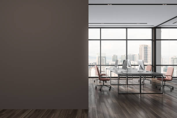 istock Modern coworking interior with pc desktop and armchairs, window. Mock up wall 1814420805