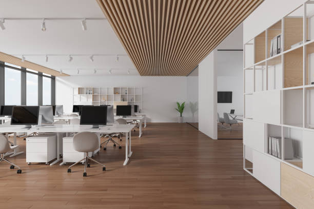 istock Cozy business loft interior with pc desktop in row, shelf and panoramic window 1814433013