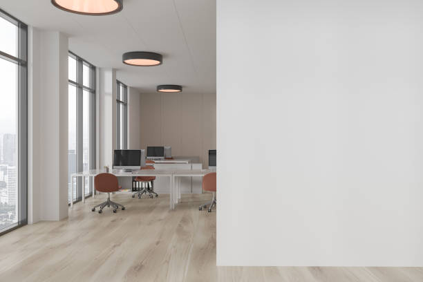 istock White and wooden open space office with blank wall 1814440477
