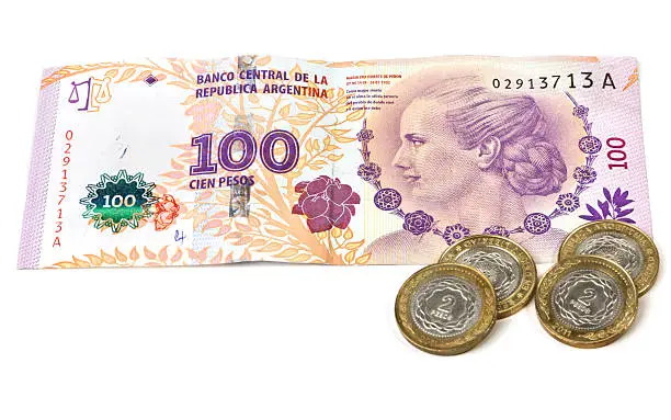Argentinian banknote with the image of Eva Peron, (Evita), and coins.