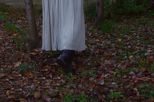 Woman Walking on the Fallen Leaves /Dark Image
