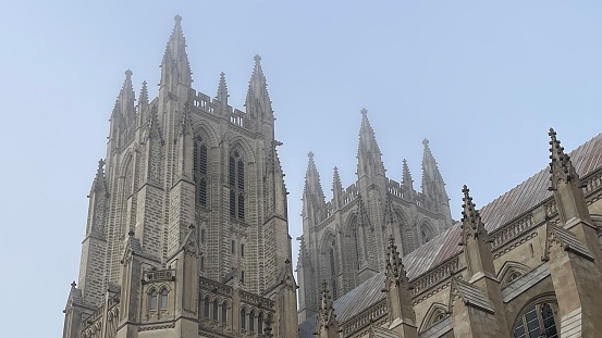 People are passing Saint Benedict church in Lincoln, England