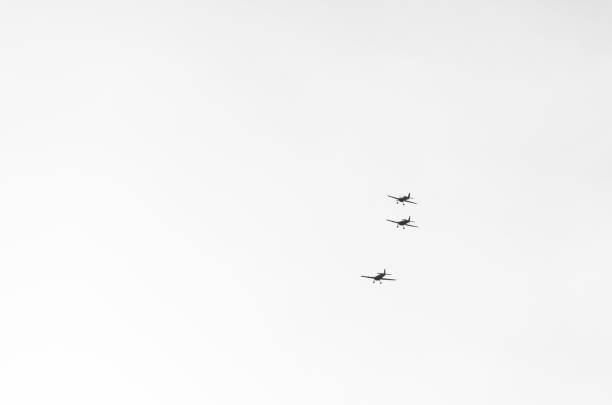 Abstract minimal picture with three small light airplanes flying on white background.