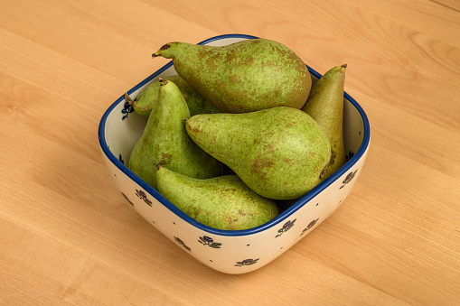 Polish pears picked in court in a bowl on the kitchen counter