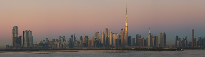 The famous Burj Khalifa receiving the first sunrays while the other skyscrapers are still in the earth's shadow.