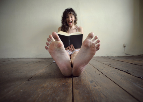 young woman reading a horror book