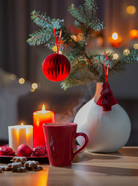 istock hot drink in red cup with christmas decorations at home 1814480671
