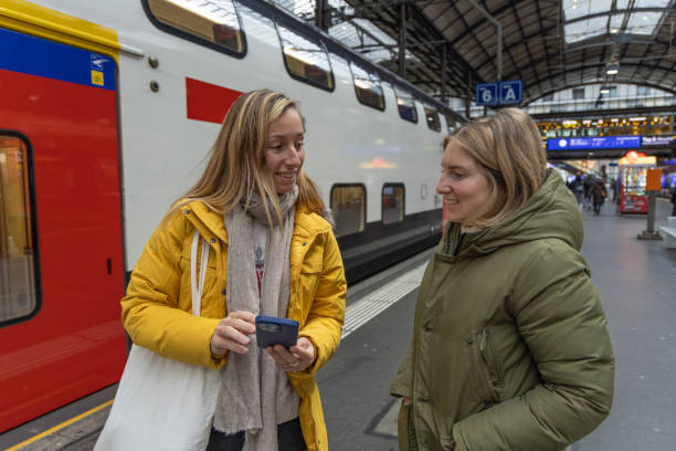istock Female chatting on train station platform using mobile phone 1814483440