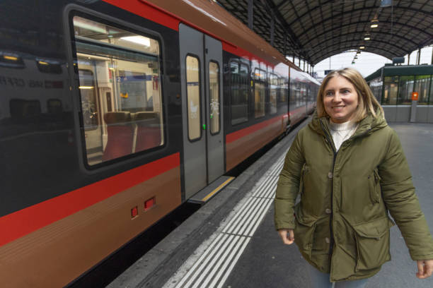 istock Female walks on to station platform, train on the side 1814484028