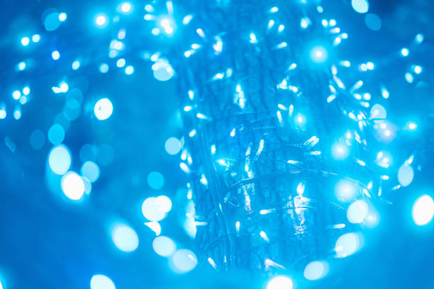 A holiday abstract lighting. Defocused bokeh lights. A shining glittering glowing background