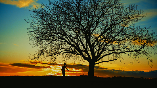 View of man standing outdoor on dawn background.