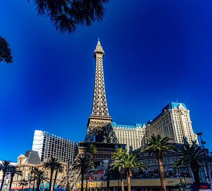 Las Vegas, USA; January 18, 2023: Photograph of the Eiffel Tower of the Paris Las Vegas Strip hotel, casino and resort on the boulevard of the city of vice, gambling and sin under a blue sky.