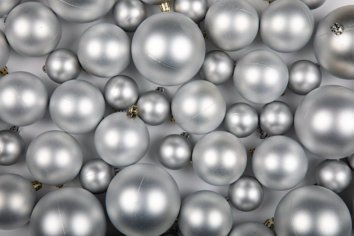 Silver Round Christmas Ornaments Background: Festive Decorative Balls for Holiday Cheer on White Background
