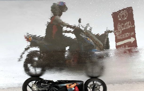 Man and couple rides motorcycle at sunset on country road