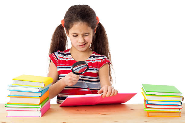 Girl with books and magnifier