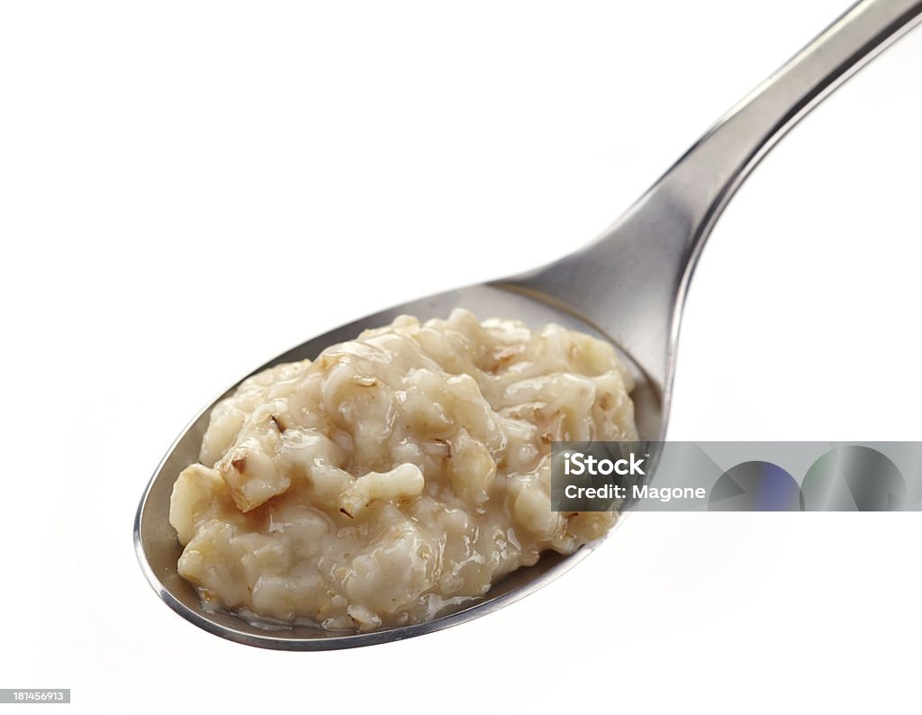 Spoon of oats porridge Spoon of oats porridge on a white background Breakfast Stock Photo