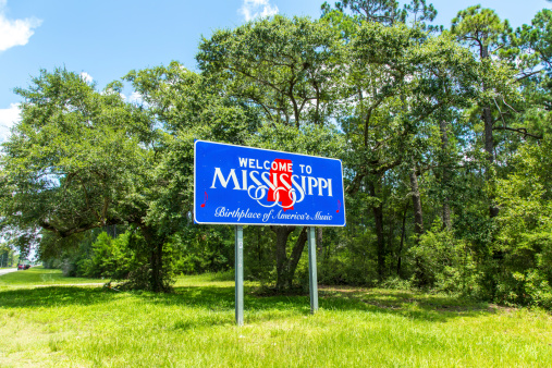 Red, white, and blue sign to welcome travelers to Mississippi - Birthplace of America's Music