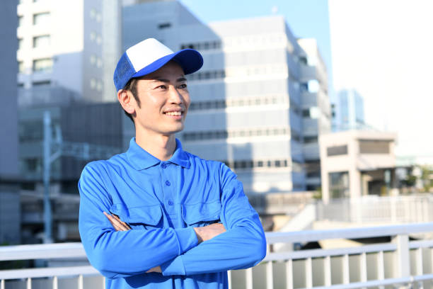 Young Asian worker with arms crossed outdoors