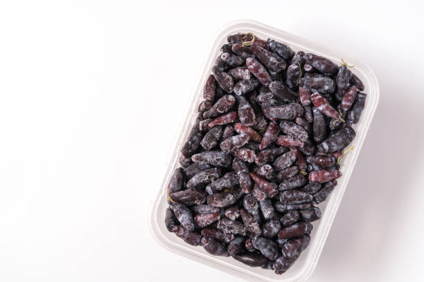 istock Frozen berries and fruits in plastic box isolated on white background. 1814604818