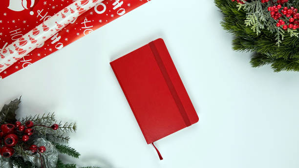 istock Juniper branches with New Year's decor. Christmas, new year background. Coniferous juniper branches, red notebook. Top view, flat design. 1814639545