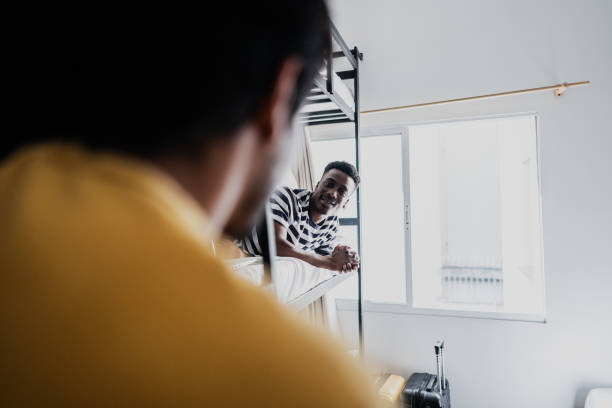 istock Young man talking with his friend in bedroom at hostel 1814657394