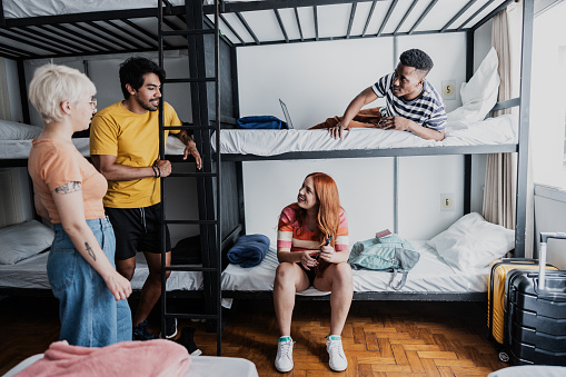 Roommates talking in bedroom at hostel