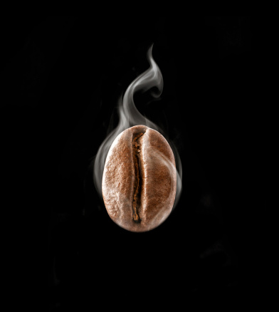Hot coffee bean in a steam on black background