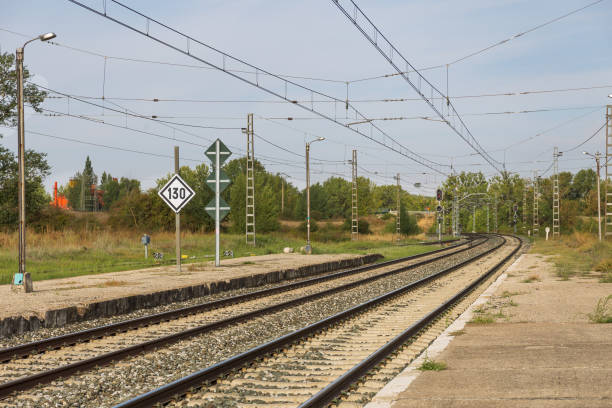 istock Railway tracks with catenaries and blue sky in the background 1814659079