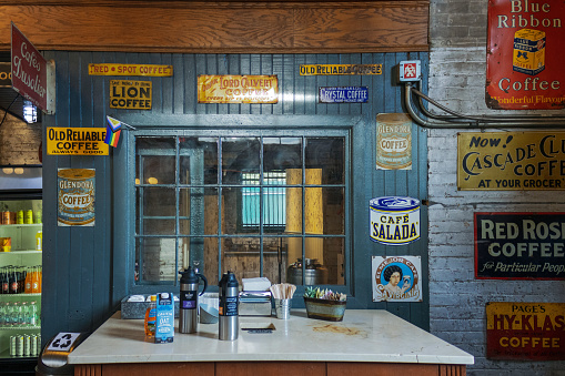 An old-fashioned coffee shop counter with vintage advertisement signs on the wall inside Balzac's coffee shop at the Distillery District in Toronto