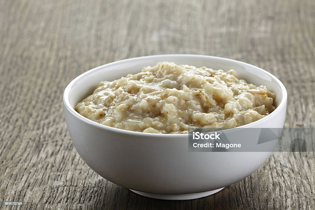 Bowl of oats porridge Bowl of oats porridge on wooden table Bowl Stock Photo