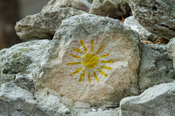 istock Mountain rocks with design sun. 1814749118
