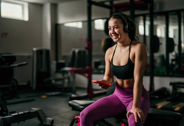 istock Woman in gym lifting heavy weights. 1814753871